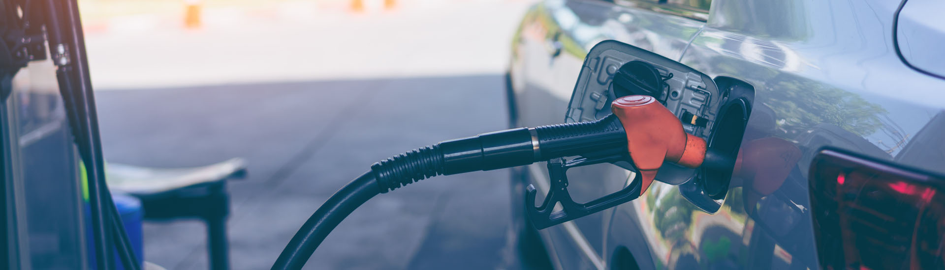 Pumping Gasoline Fuel in Car at Gas Station
